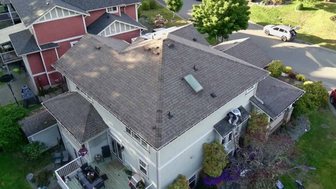 Completed architectural asphalt shingle roof on a two-storey residential home